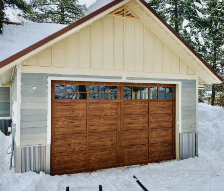 Snow surrounding garage door